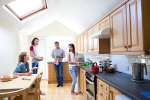 Four students gather and work in the kitchen